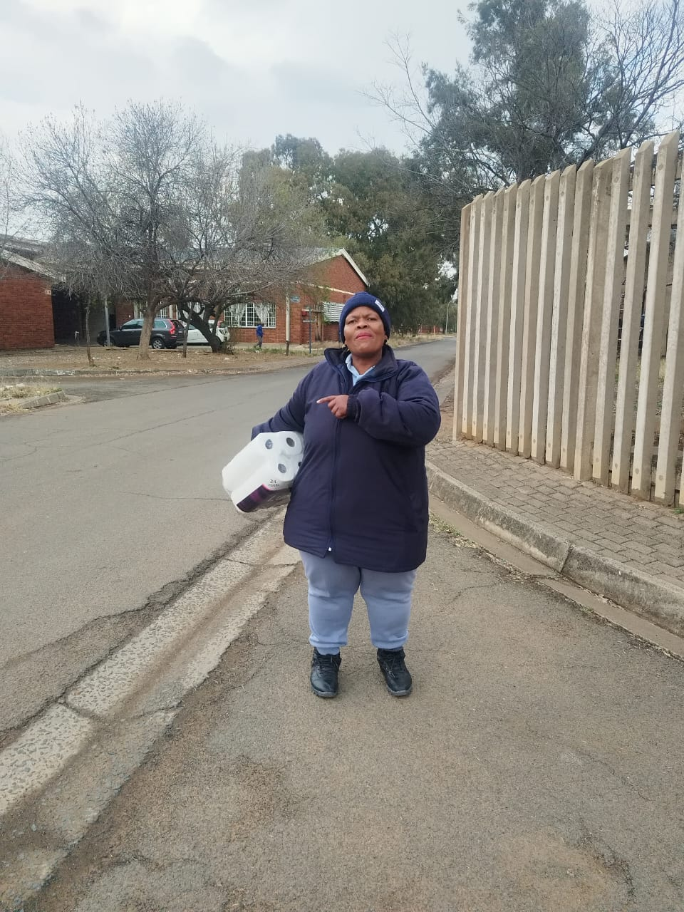 Customer in the street with her Mokgadi Enterprise tissue pack